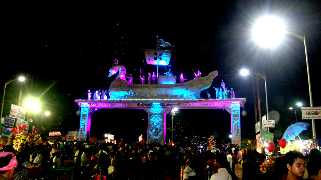 Balijatra festival celebration in Cuttack Odisha with traditional stalls, crowd, and cultural activities near Mahanadi river
